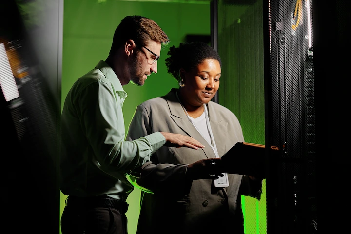 Two people looking at a laptop